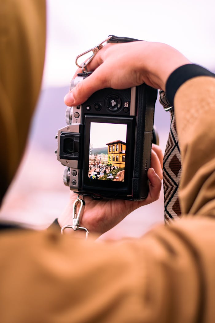 A photographer captures Bursa's vibrant yellow building through a digital camera.